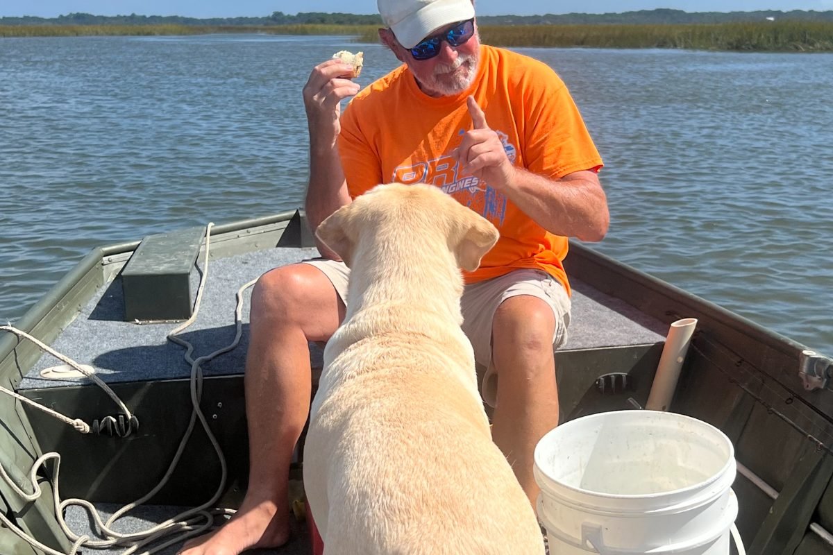 A club member fishing with his dog