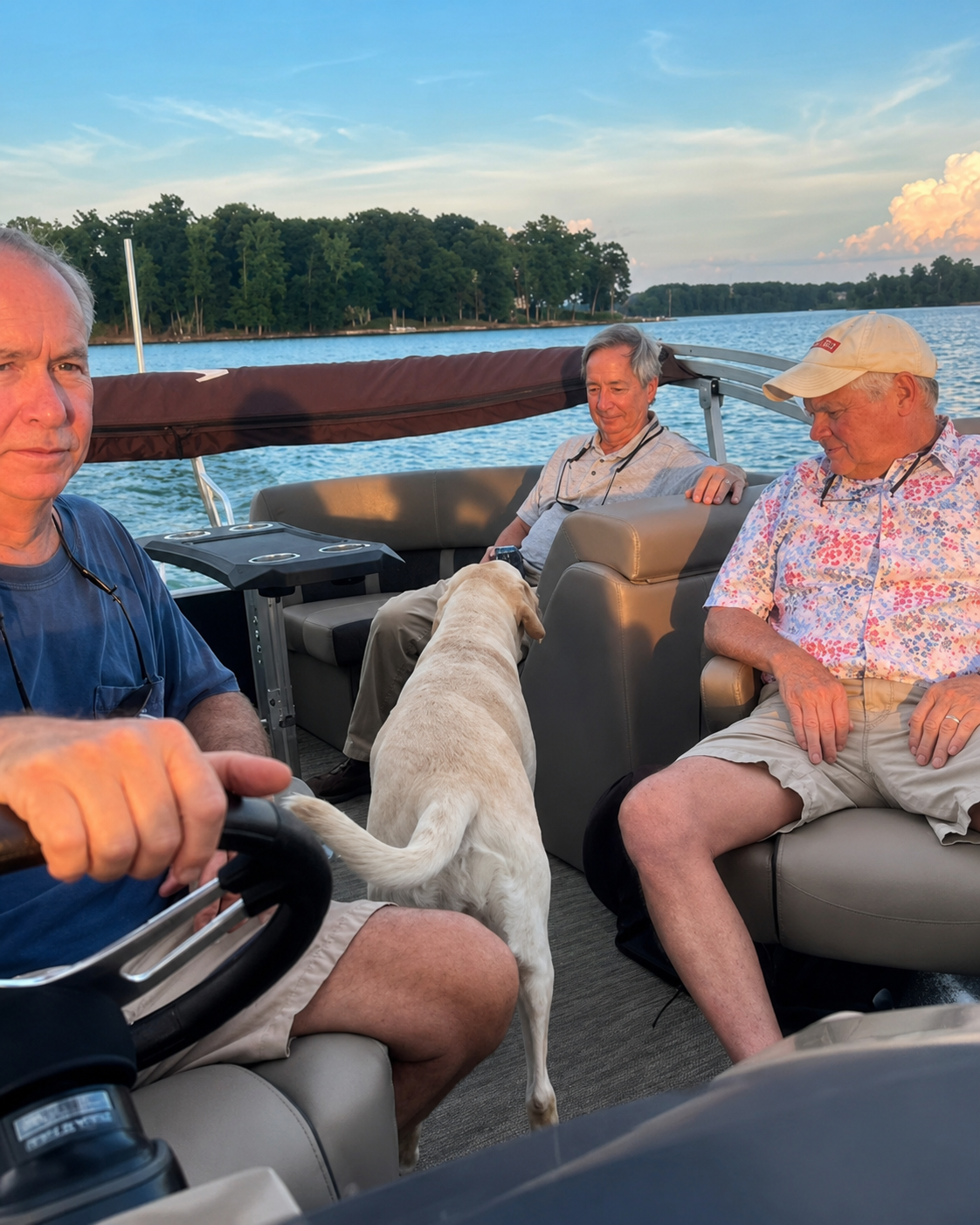 Three club members and a dog out on the lake