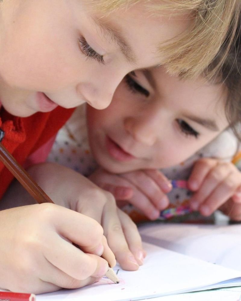 A student reading her winning essay aloud at the community centre — February 2026