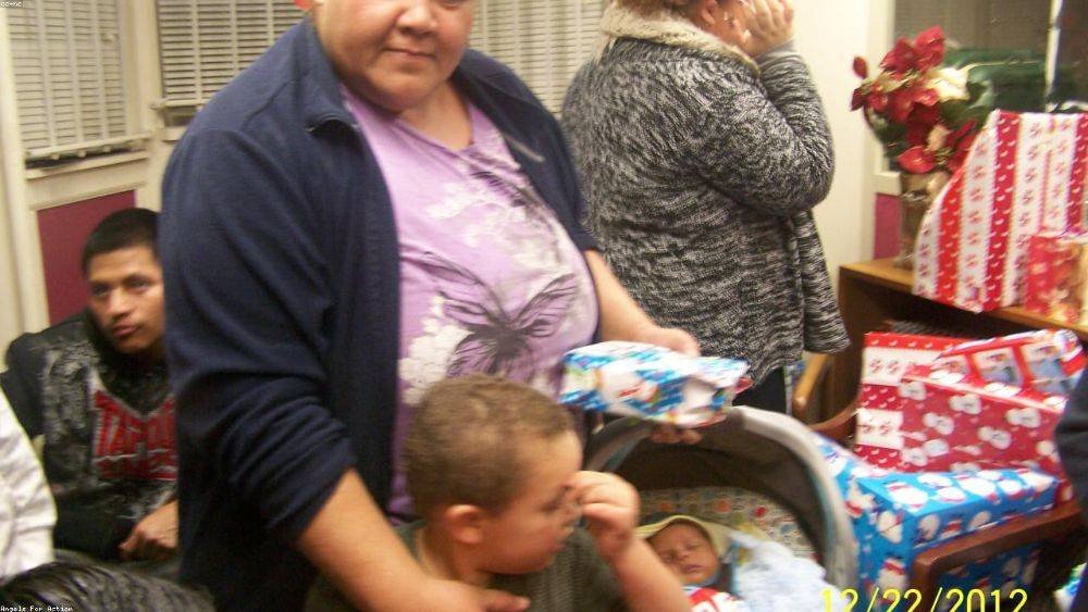 Volunteers loading wrapped gifts into a pickup outside the fire station — December 2025