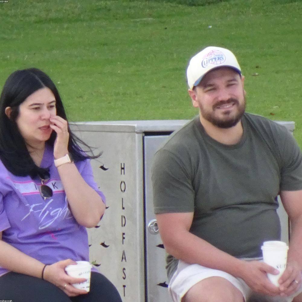 Two members deep in conversation over coffee after the meeting — January 2026